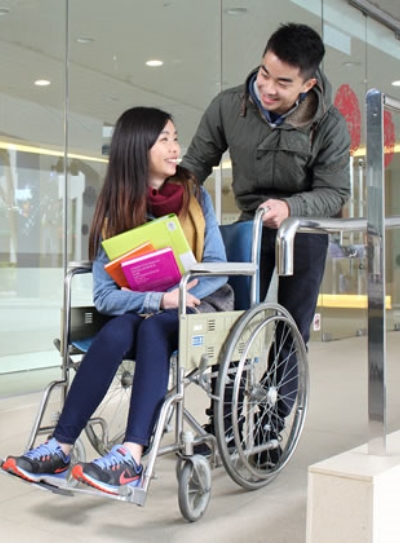 Man helping people who siting wheelchair